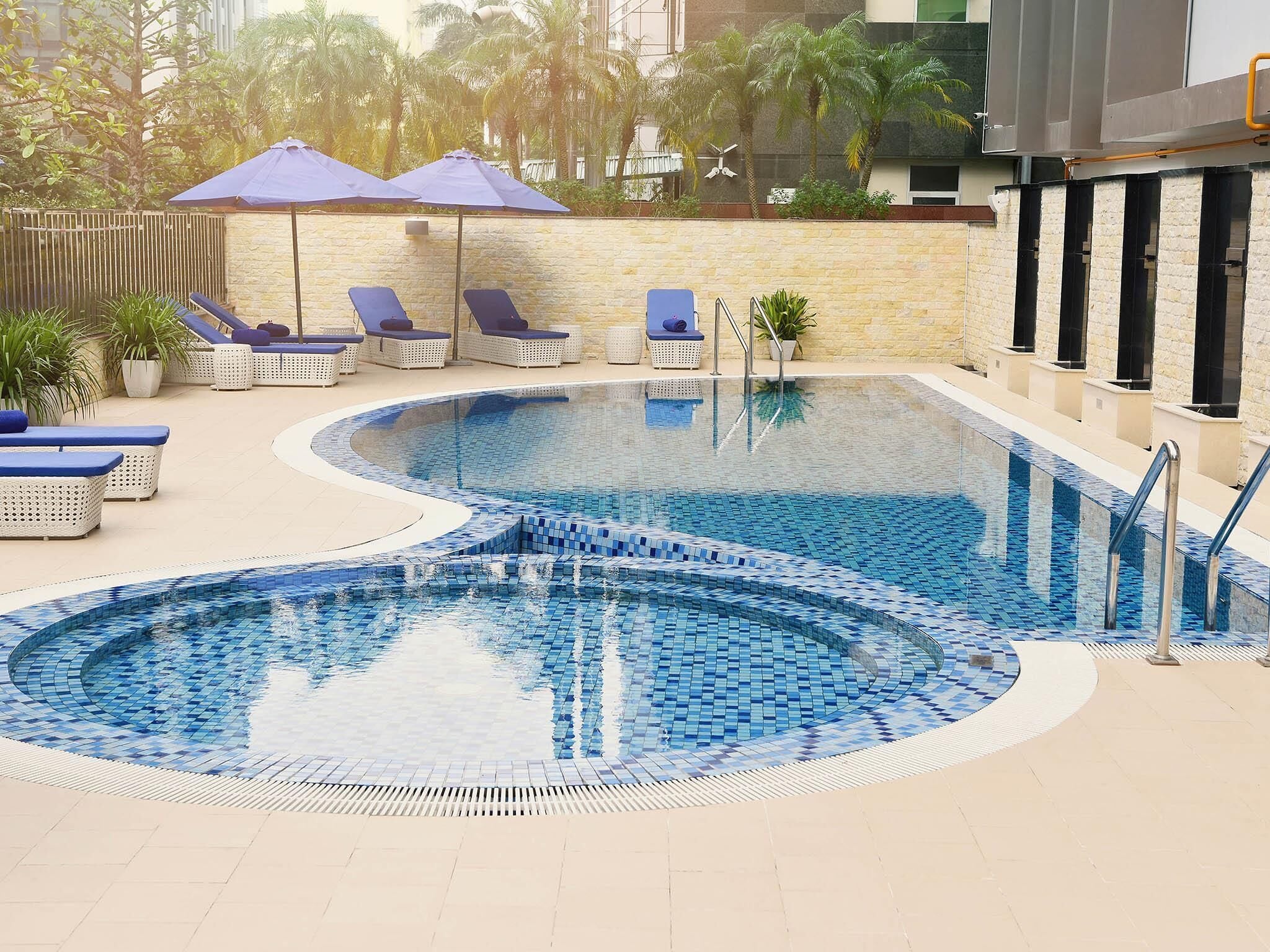 Outdoor pool, open 6:00 AM to 10:00 PM, pool umbrellas