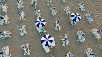 Playa privada, sillas reclinables de playa, sombrillas