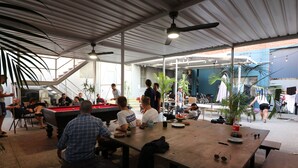 A casual dining area with a pool table, seating, and a view of the outside. - Britannia on William - Hostel (Perth)