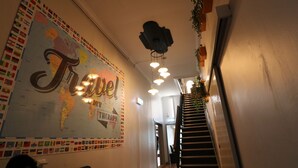 A hallway with a large wall map and the word "Travel" prominently displayed. - Britannia on William - Hostel (Perth)