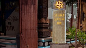 A hotel entrance with a sign reading "Segara Sadhu Inn" and a decorative star above it. - Segara Sadhu Inn Kuta by ecommerceloka (Kuta)