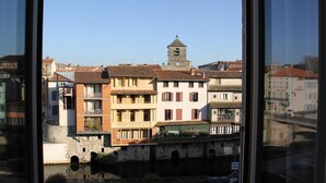 Vista de un pueblo histórico con una torre destacada y un puente.