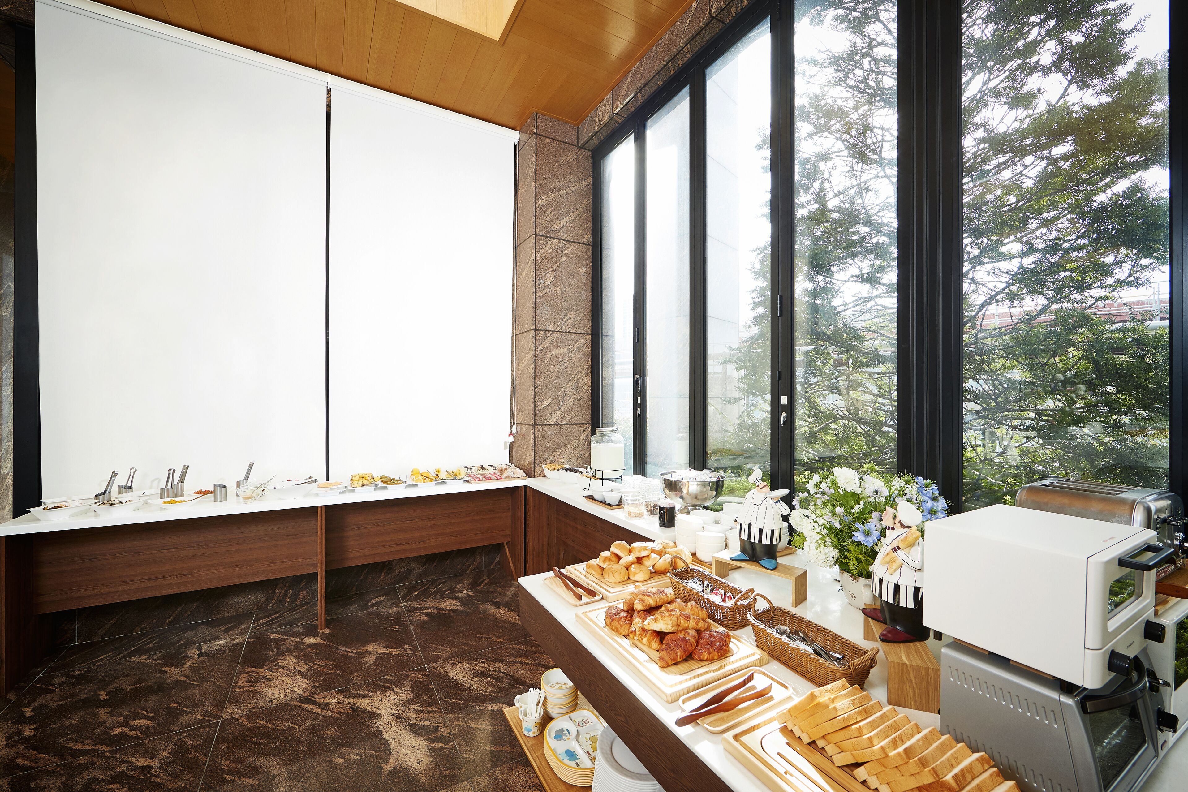 A breakfast buffet with various food items and a coffee machine.