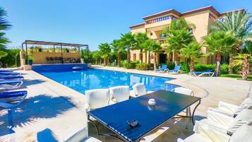 Outdoor pool, a natural pool, pool umbrellas, sun loungers
