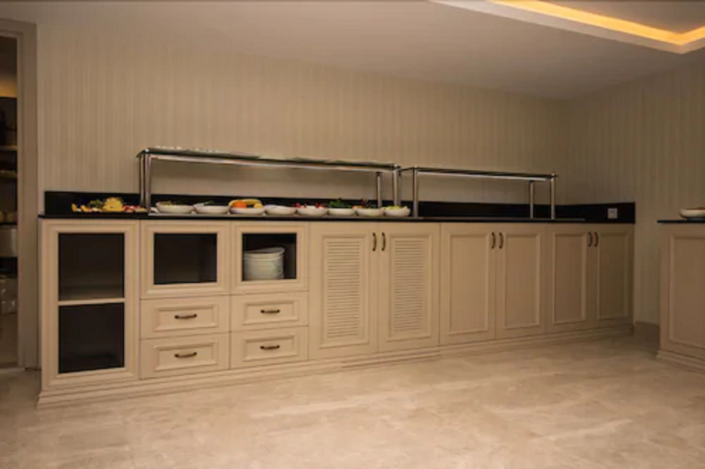 A kitchen with a countertop, cabinets, and a backsplash.