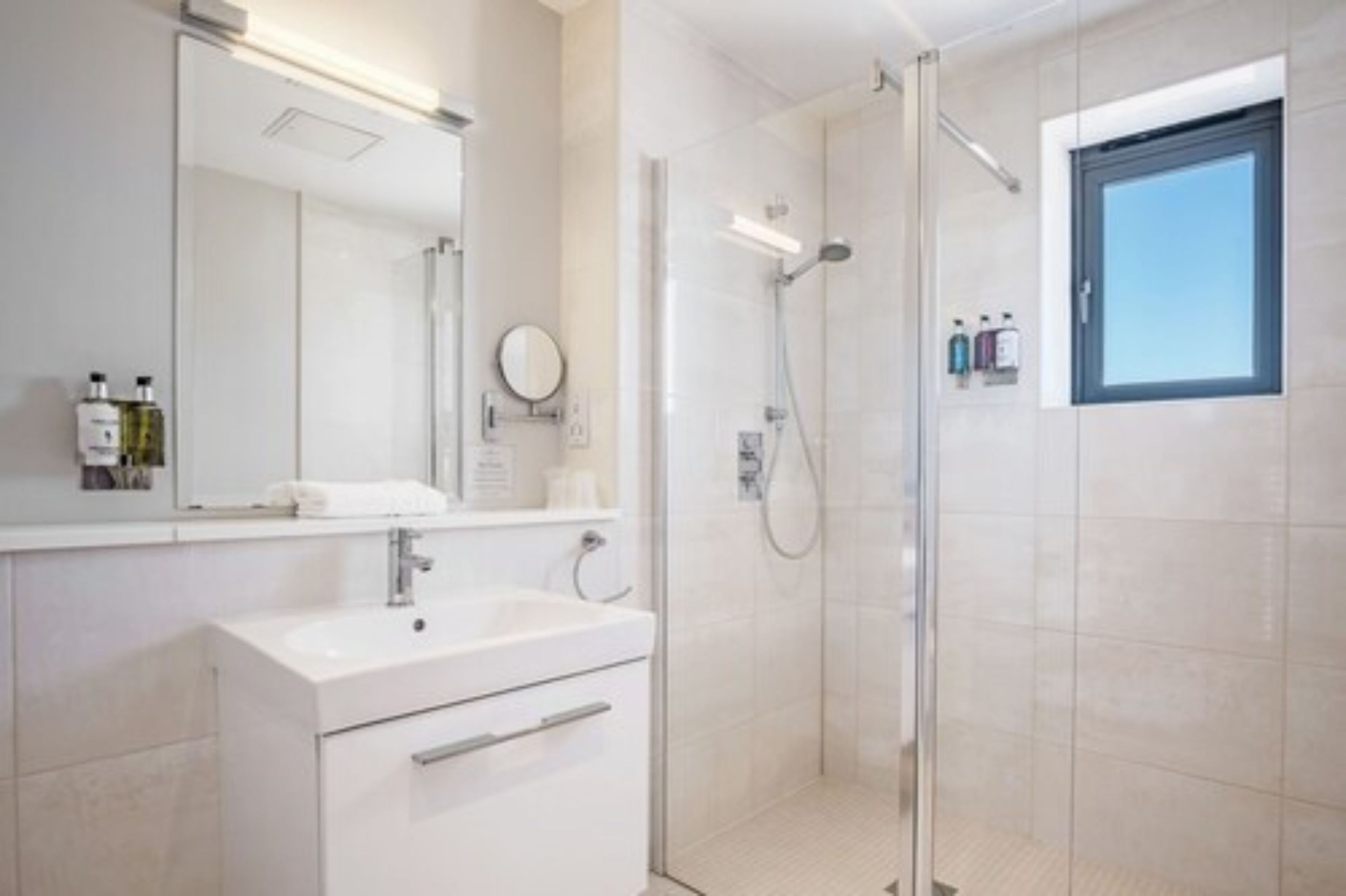 designer toiletries, hair dryer, towels, soap