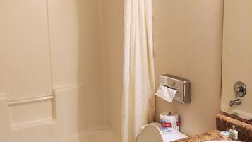 A bathroom with a bathtub, toilet, and sink.