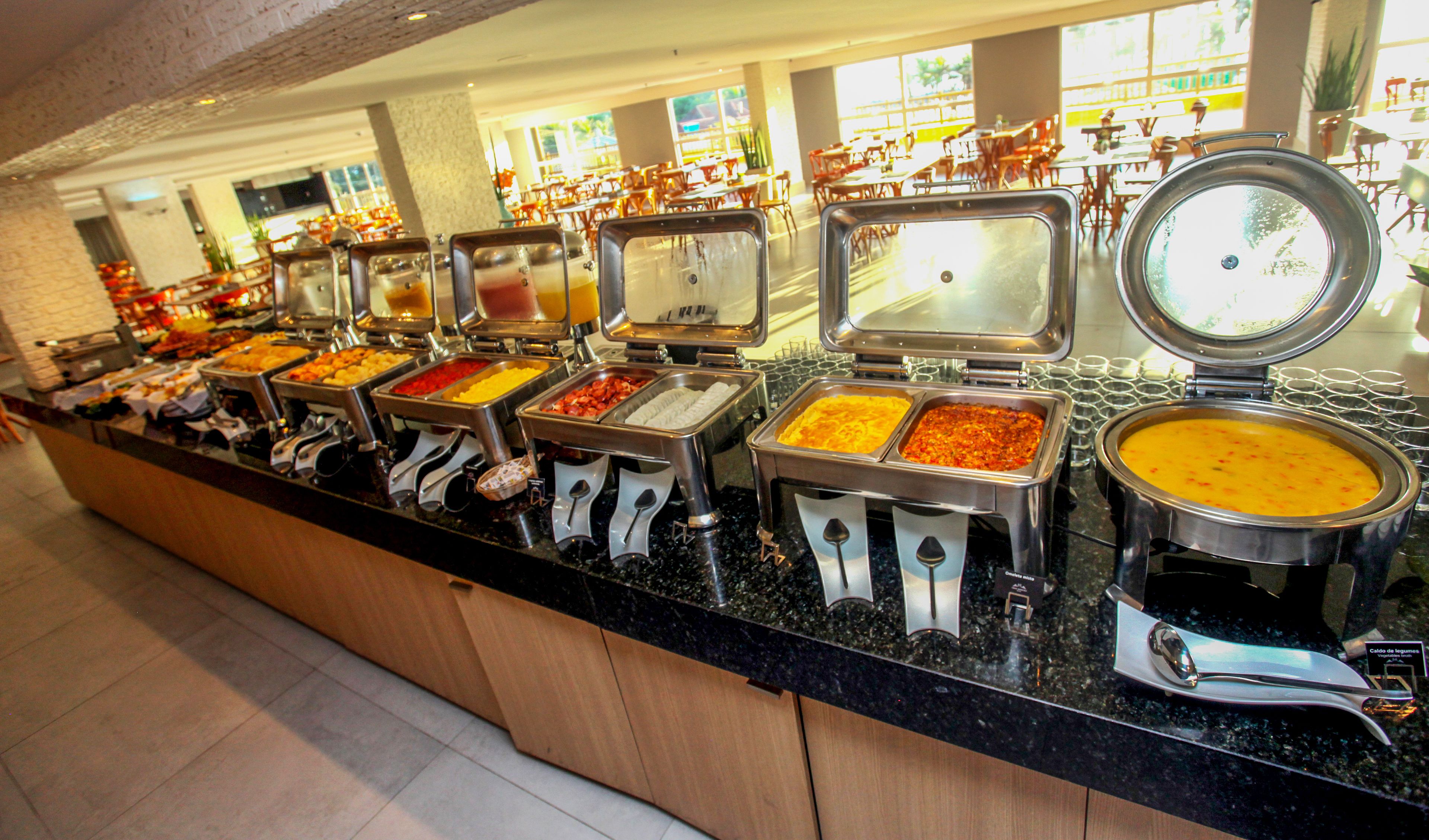 A buffet with multiple food stations and a variety of dishes.