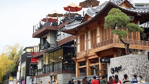 A traditional wooden building with multiple balconies and outdoor seating areas. - Myeongdong Merlin Hotel (Seoul)
