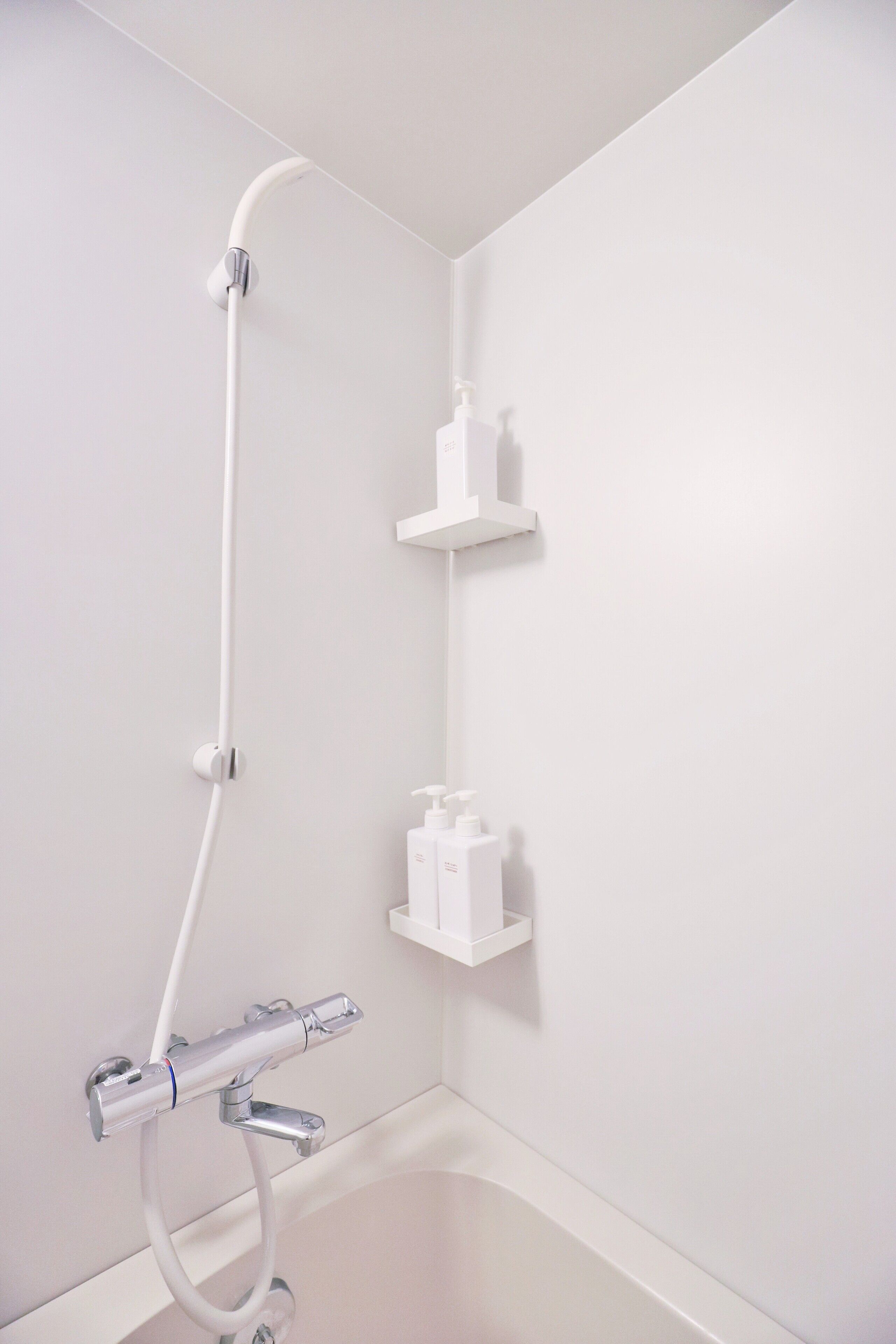 A modern bathroom with a shower, a toilet, and a sink.