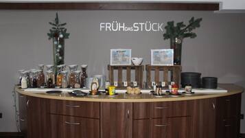 A breakfast bar with jars of condiments, a coffee machine, and a menu board.