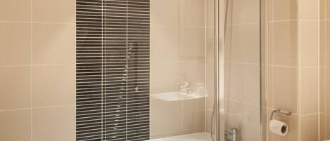 Une salle de bain moderne avec une douche à parois de verre, une baignoire sur pieds et des toilettes.