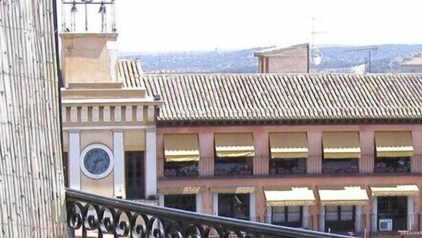 Un edifici amb teulada enrajolada i diversos balcons.