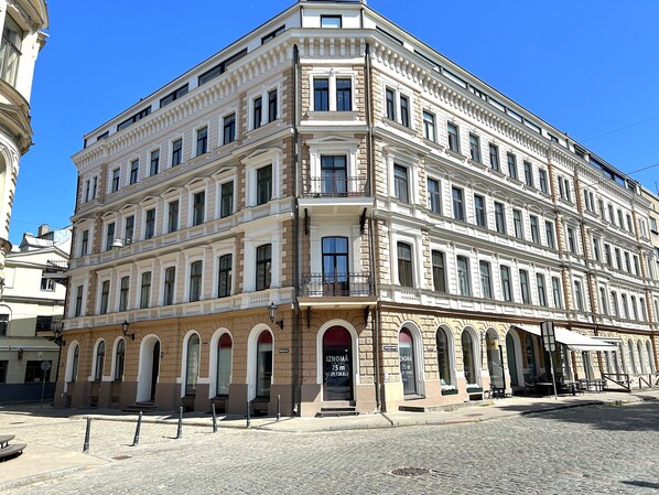 A multi-story building with a classical architectural style, featuring arched windows and a symmetrical facade.