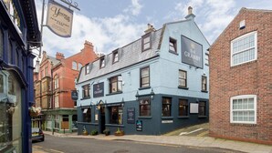 A traditional pub with a sign for 'The Granby Hotel & Bar' and a 'Live Sports' sign outside.