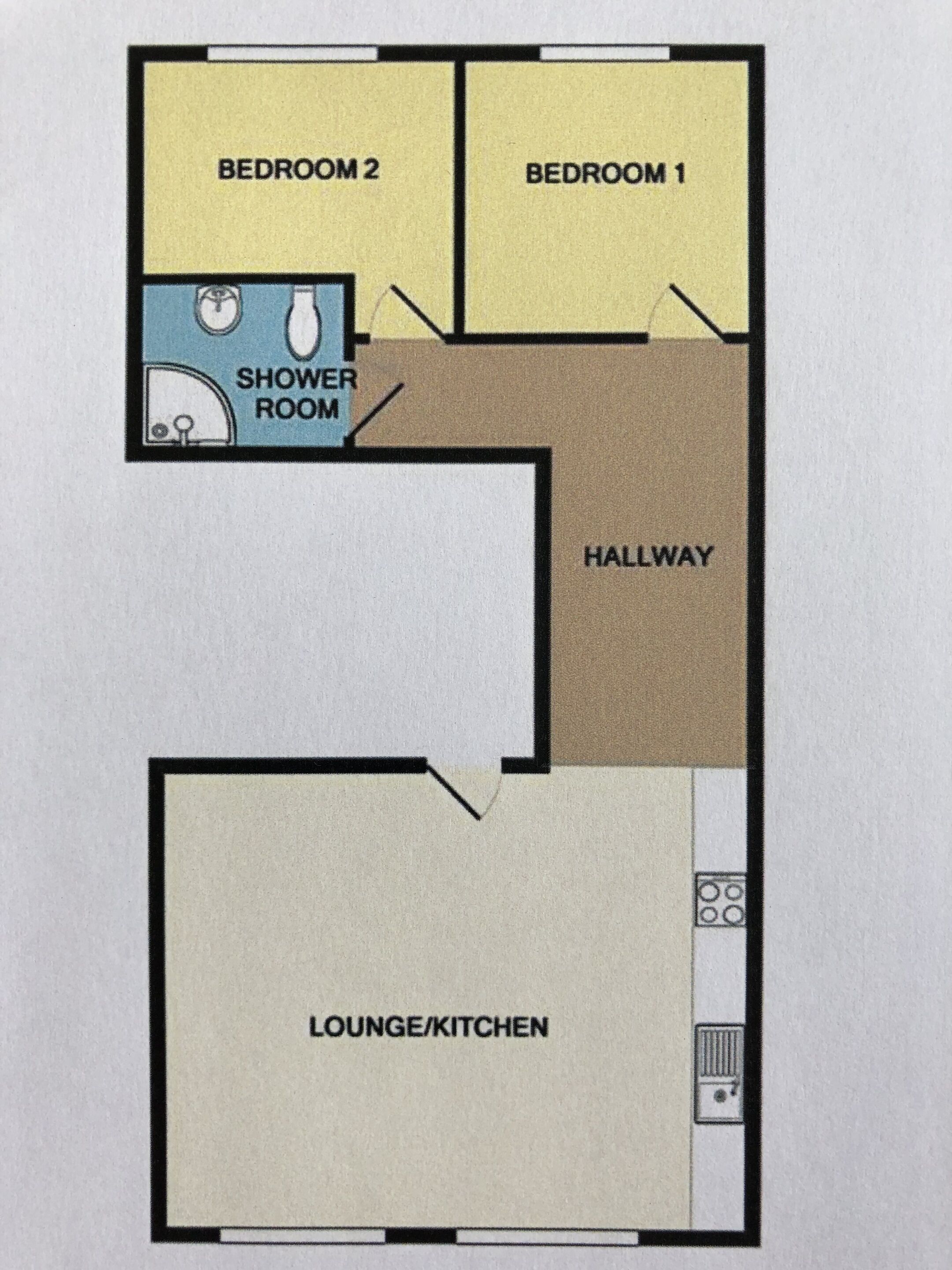 A floor plan with two bedrooms, a shower room, a hallway, and a lounge/kitchen area.