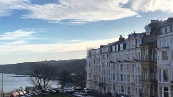 A row of terraced houses with a view of the sea.