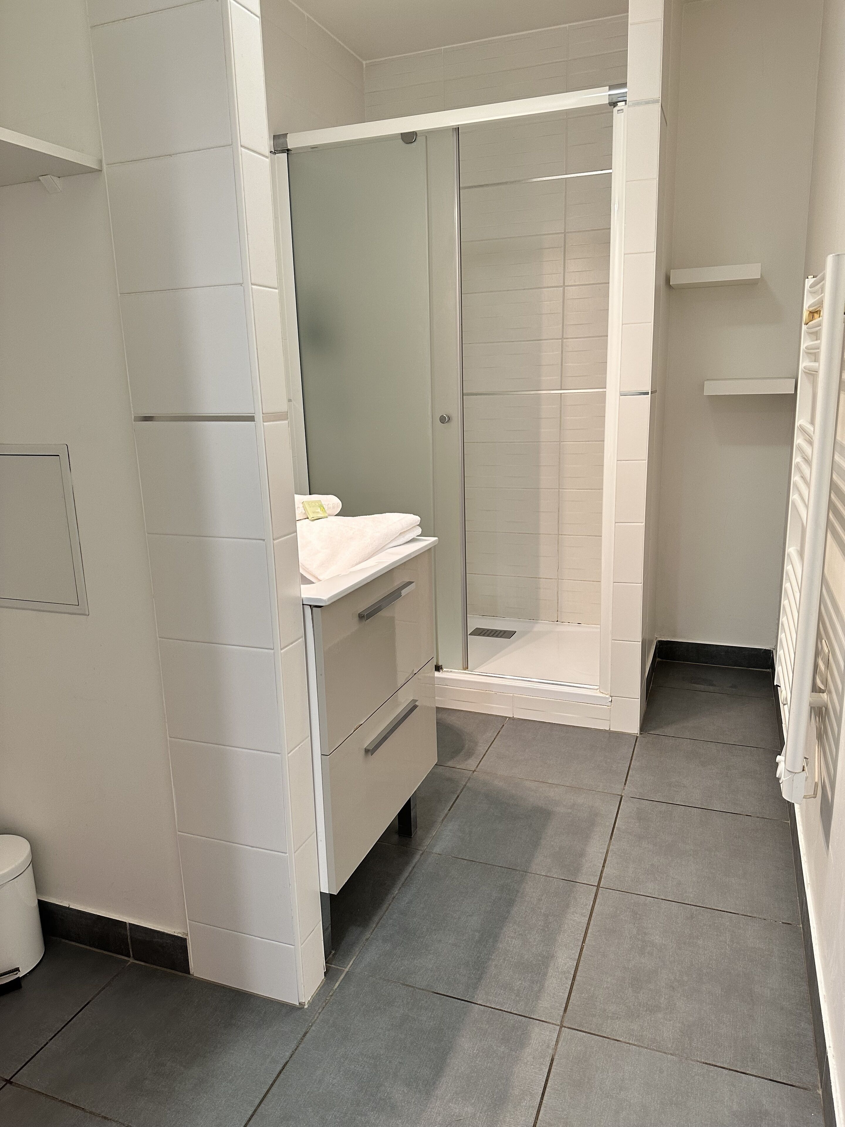 A bathroom with a shower, a toilet, and a sink.