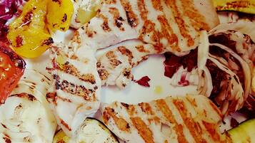 A plate of grilled vegetables and chicken.