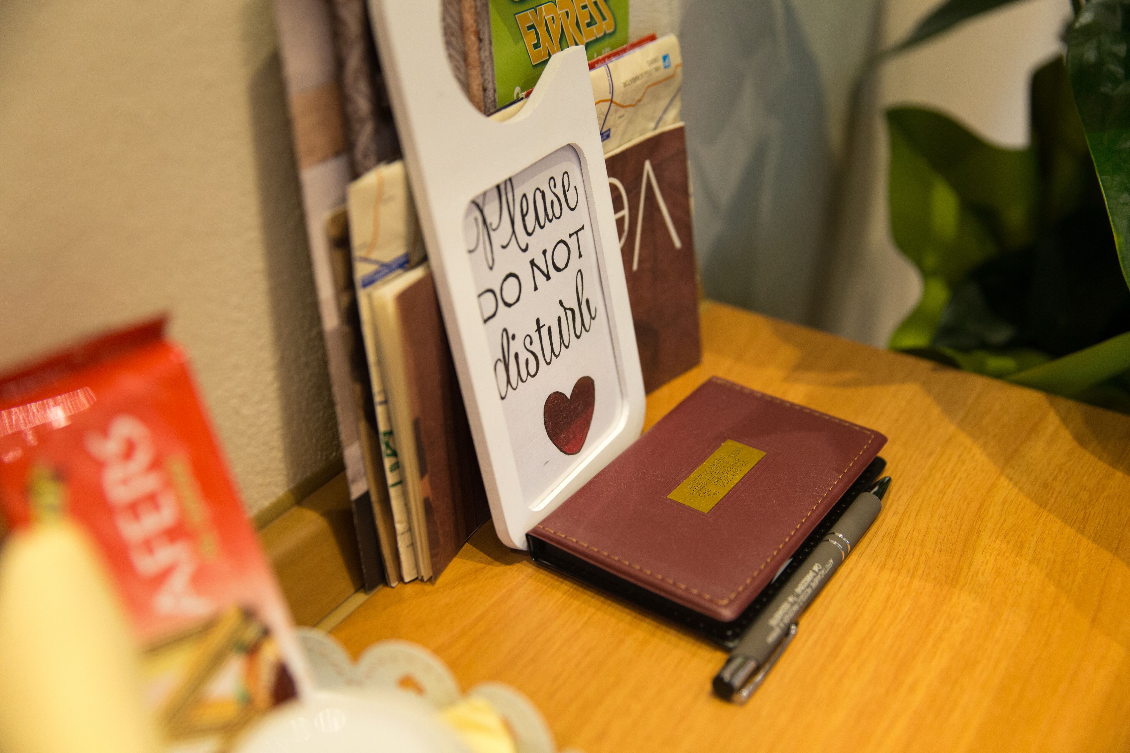 A table with a notebook, a pen, and a sign that says "Please do not disturb."