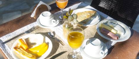 A table set with breakfast items including toast, fruit, and a glass of orange juice.