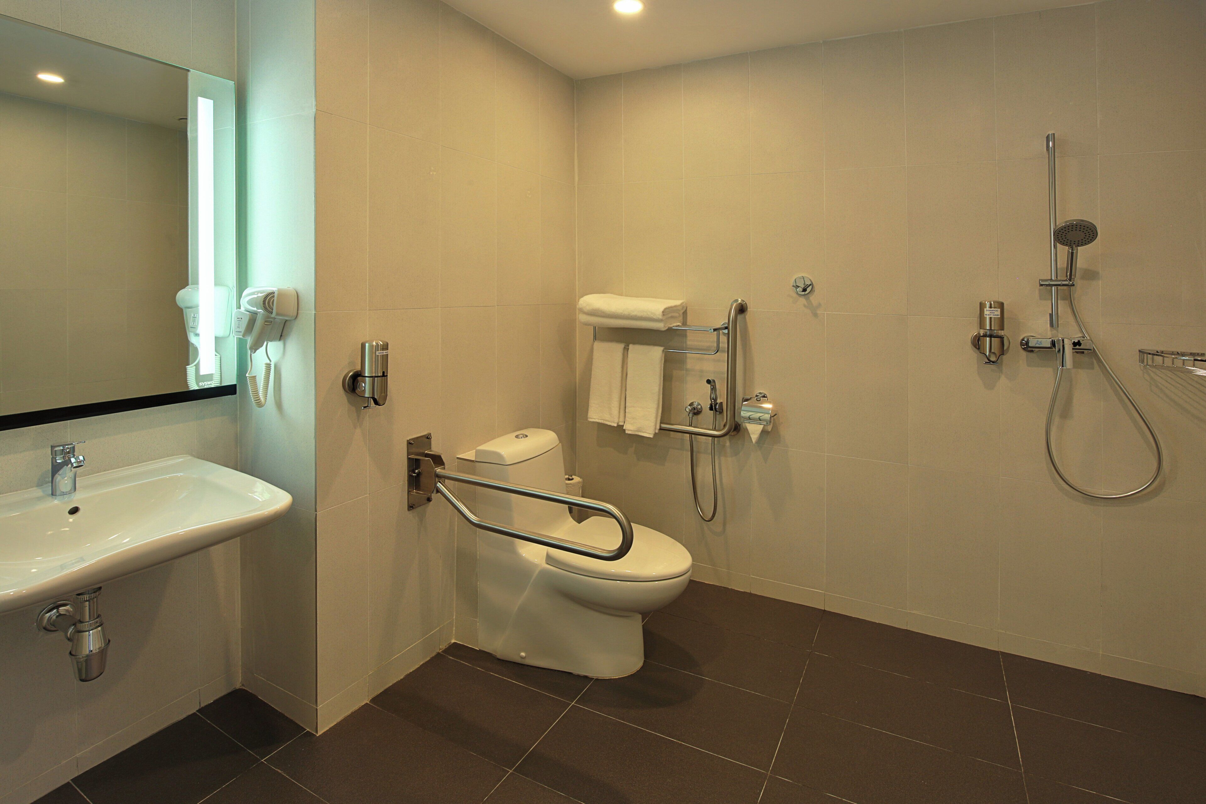A modern bathroom with a sink, toilet, and shower.