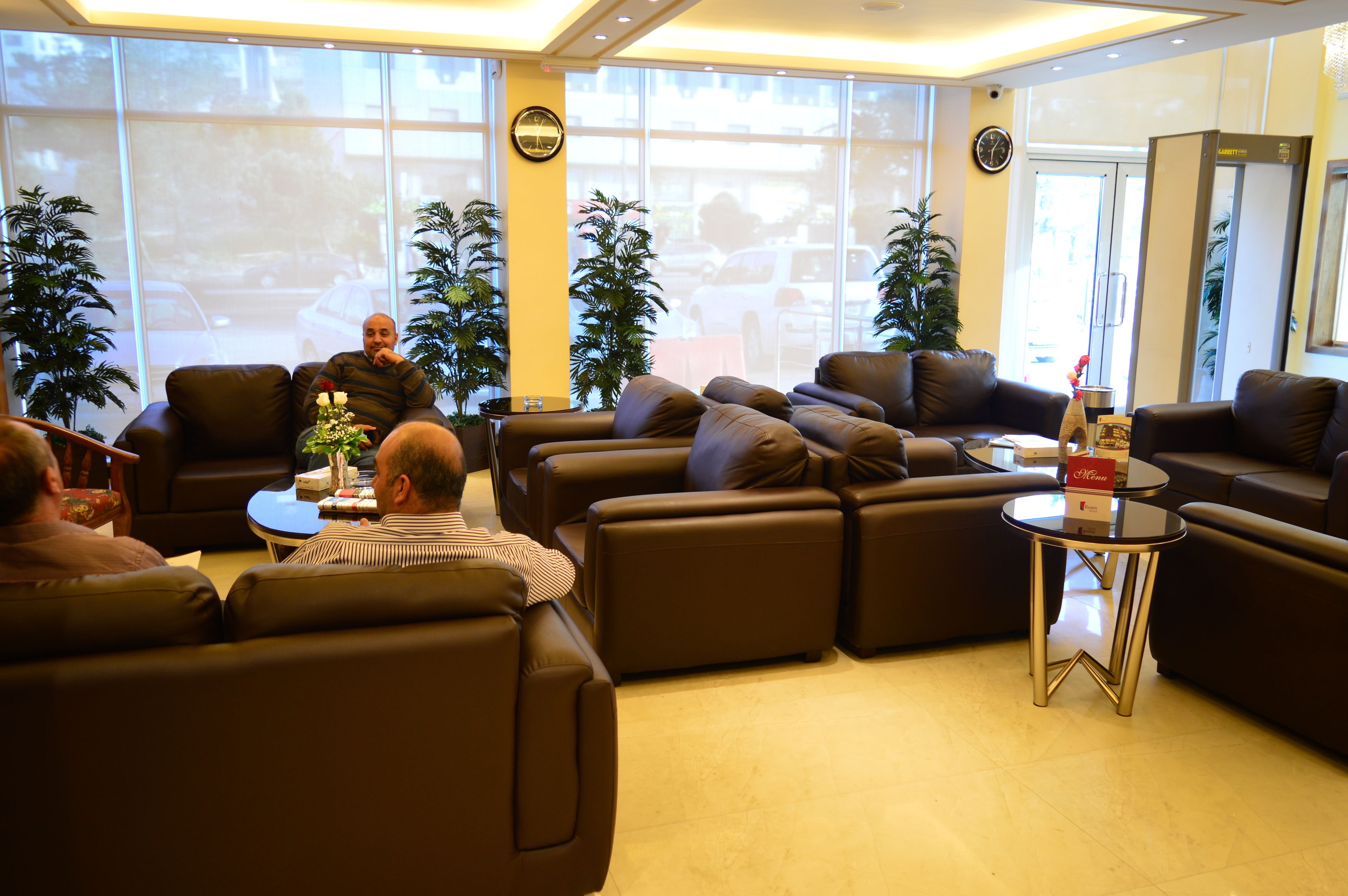 A modern lounge area with leather sofas and a glass coffee table.