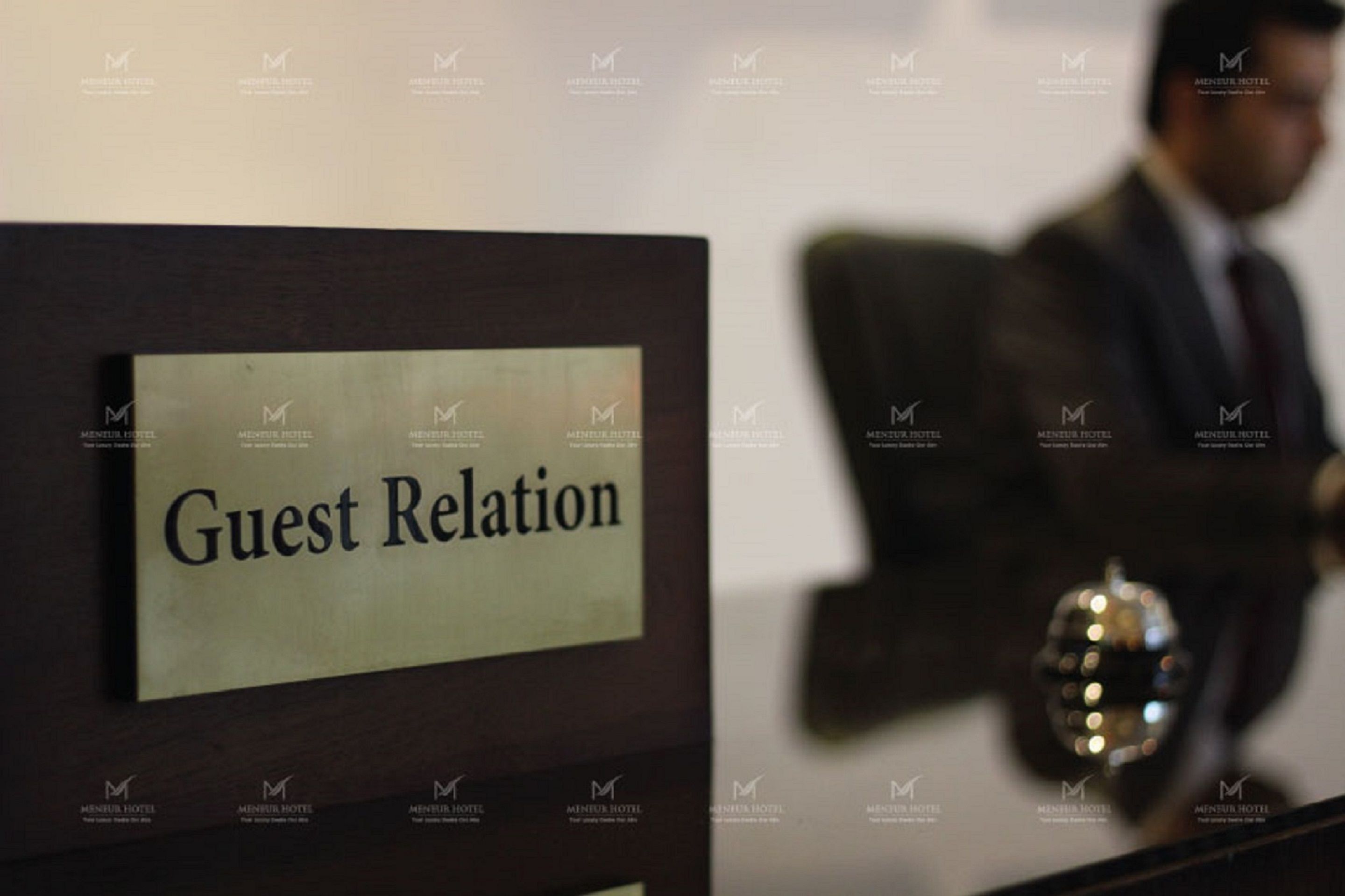 A sign labeled "Guest Relation" in a hotel setting.