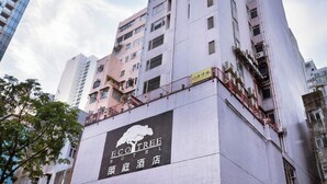 A hotel building with a prominent sign for Eco Tree Hotel.