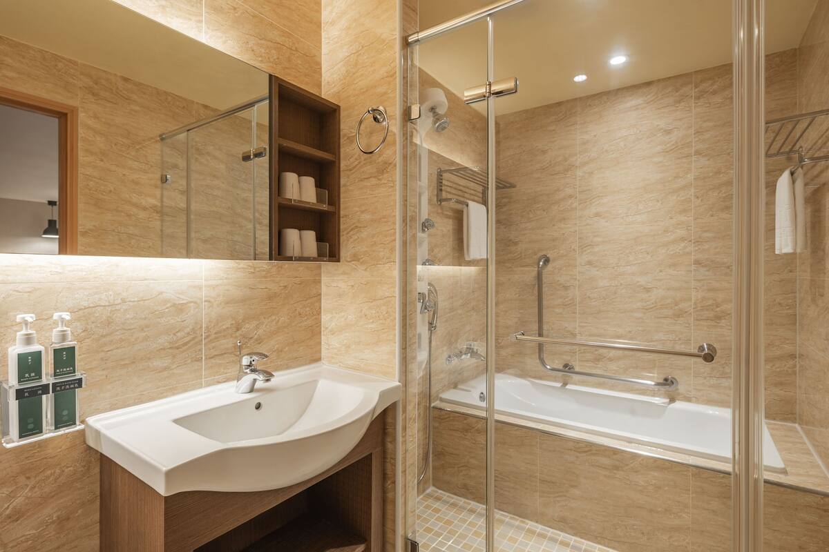 shower, hair dryer, slippers, towels