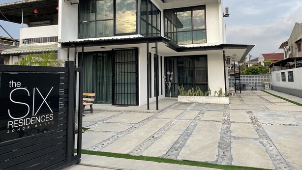 A modern two-story residential building with large windows, a gated entrance, and a paved driveway. - The Six Residences at JB Sentosa (Johor Bahru)