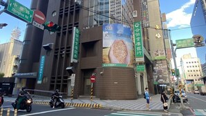 A modern building with large windows and a prominent advertisement for a cereal brand.