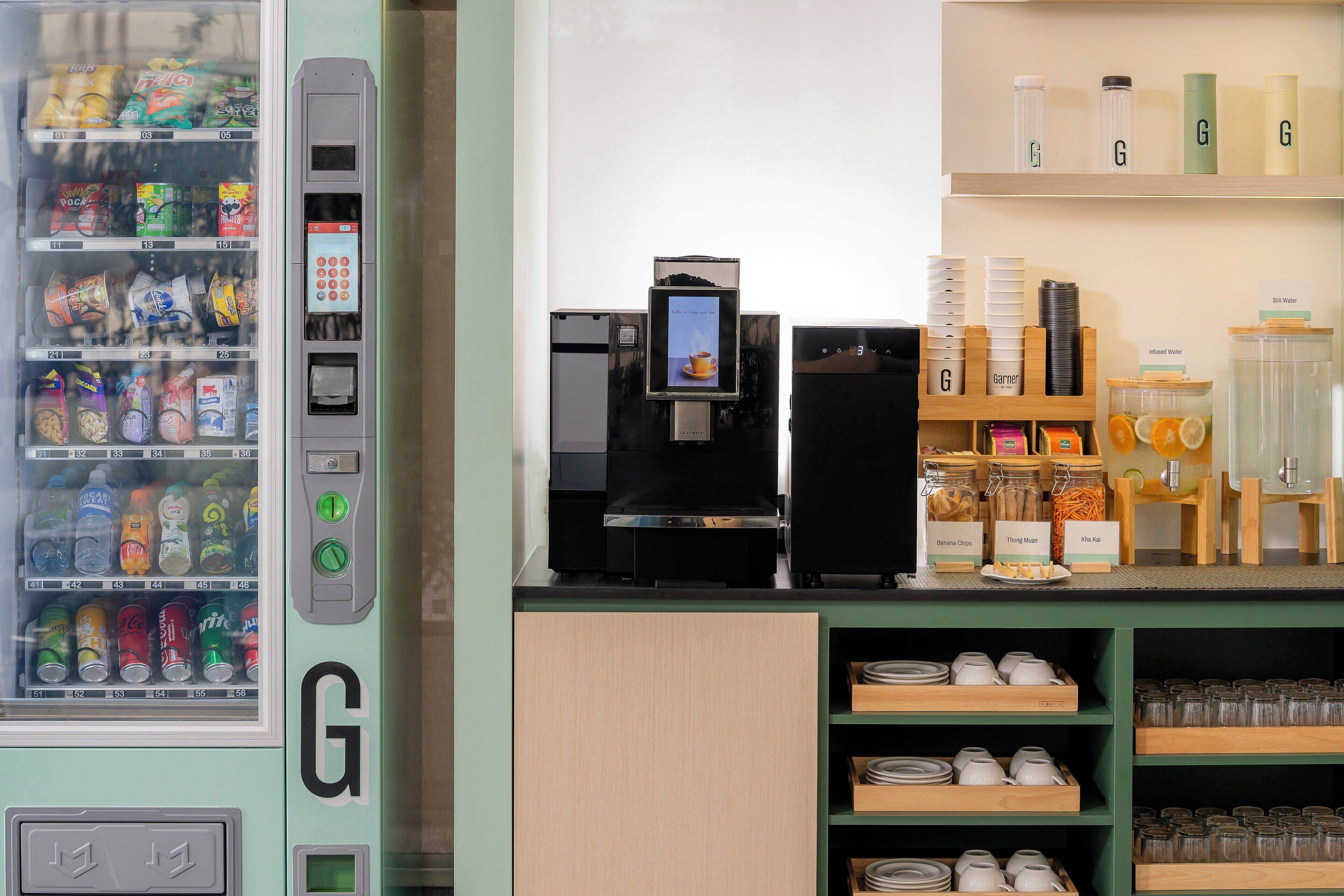 A vending machine with snacks and drinks, a coffee machine, and a display of jars and containers.