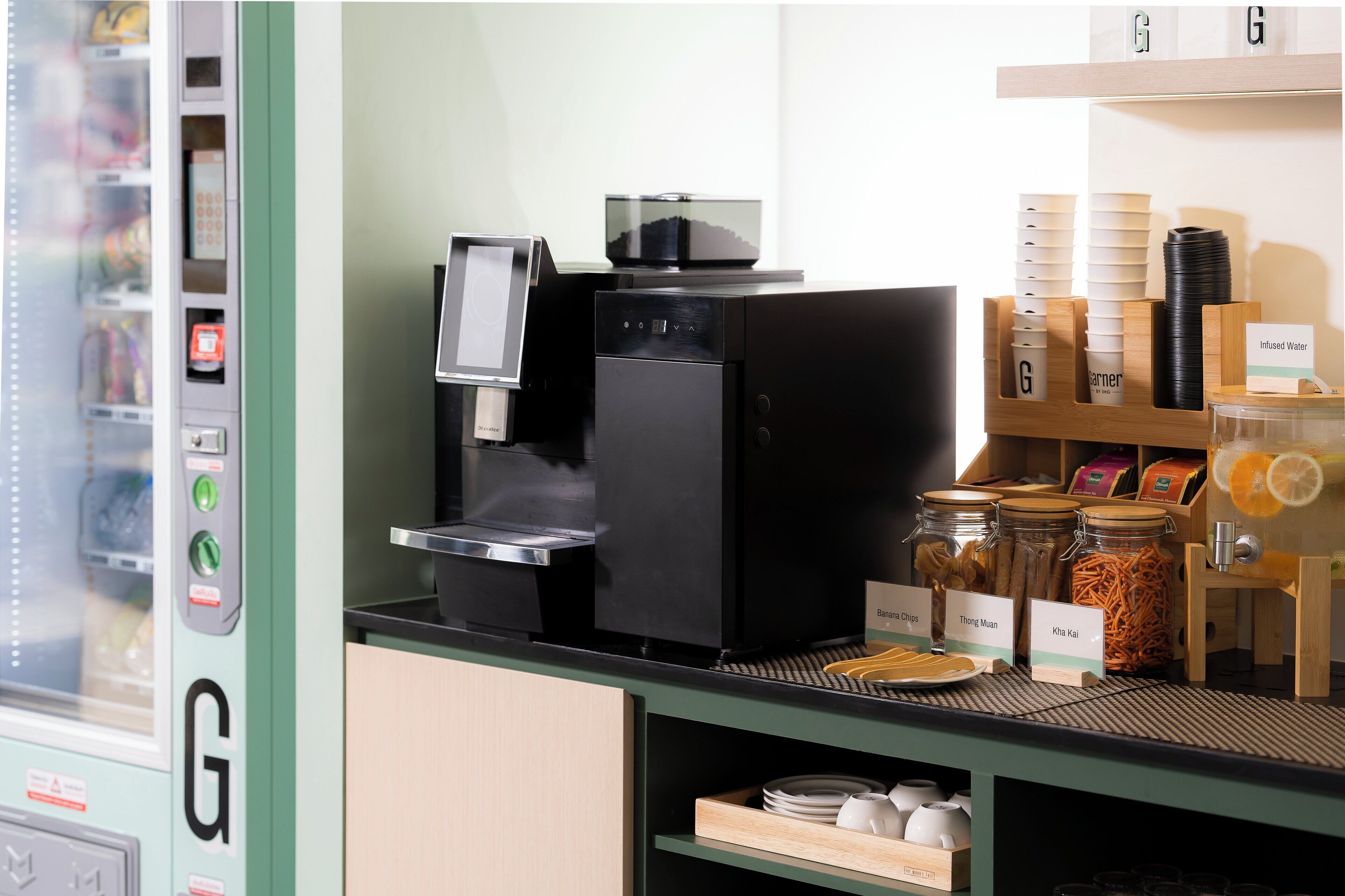 A coffee machine, condiment dispensers, and a variety of food items on a counter.