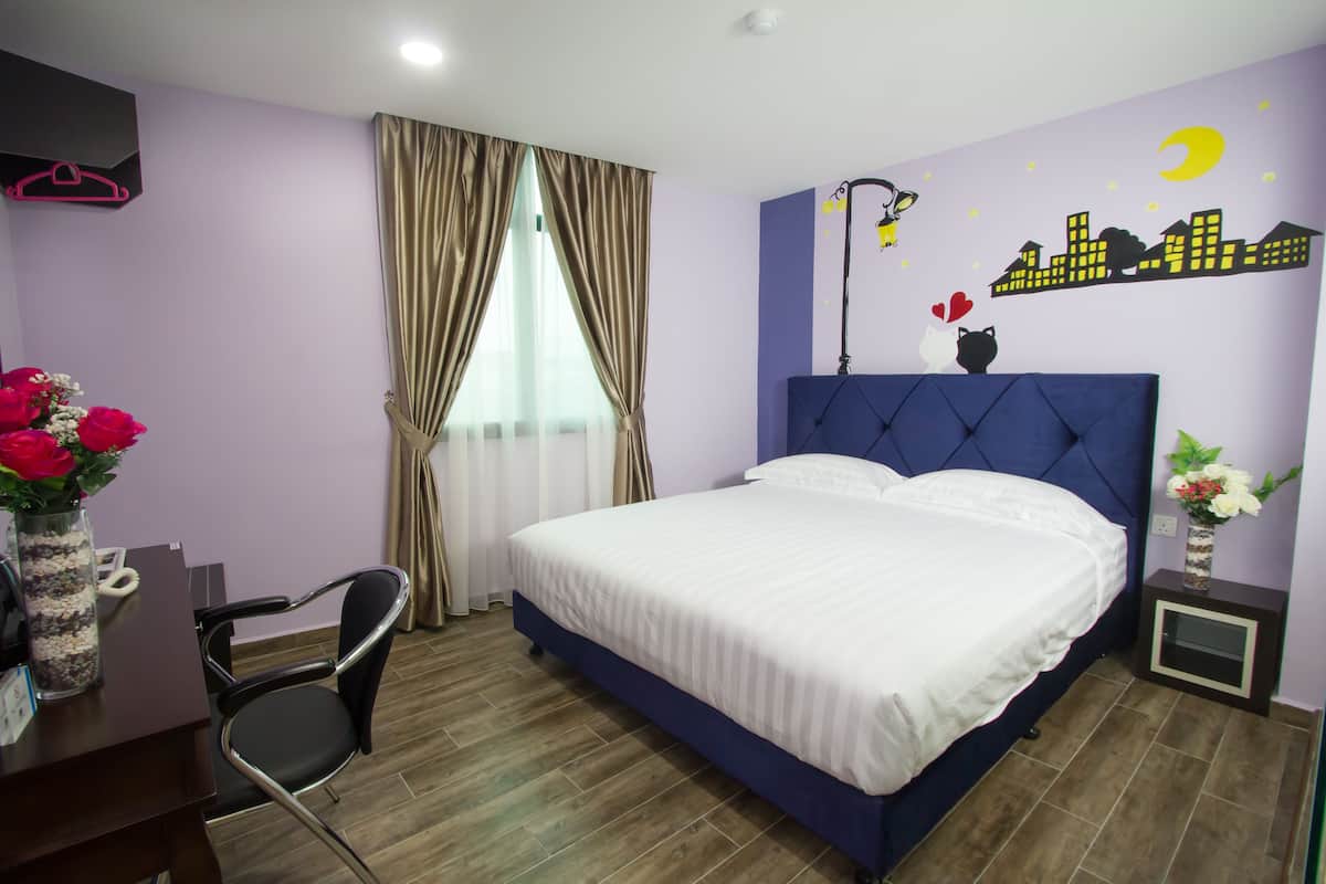 A bedroom with a large bed, a desk with a chair, a nightstand, and a wall with a cityscape mural.