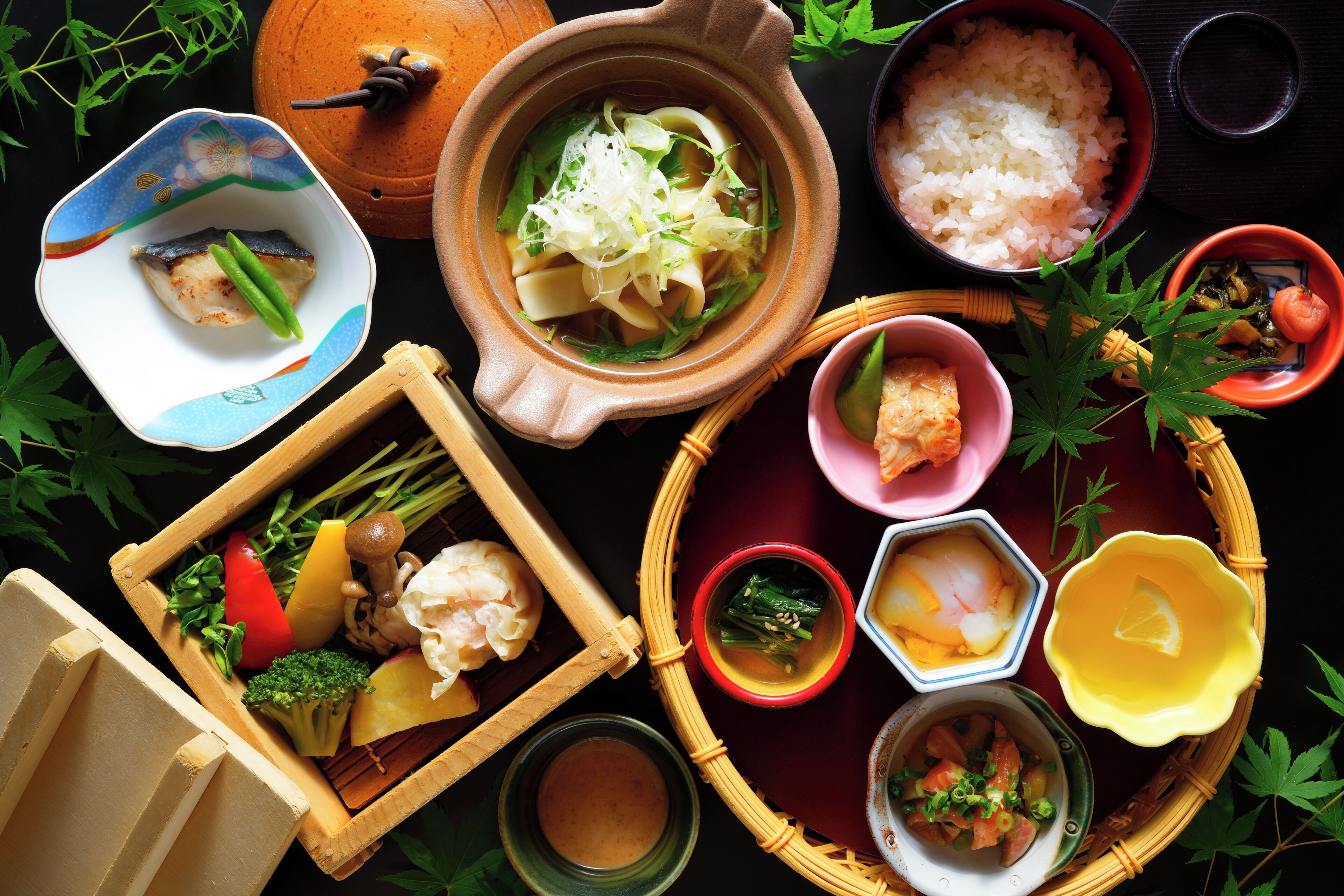 A variety of dishes and food items arranged on a table.