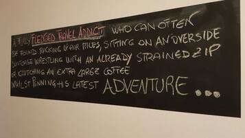 A blackboard with text describing a 'fully flexed travel addict' and their behaviors.