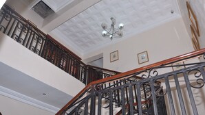 A multi-level interior with a staircase featuring ornate black railings and wooden handrails. - Preserve Hotel Lekki Phase 1 (Lekki)
