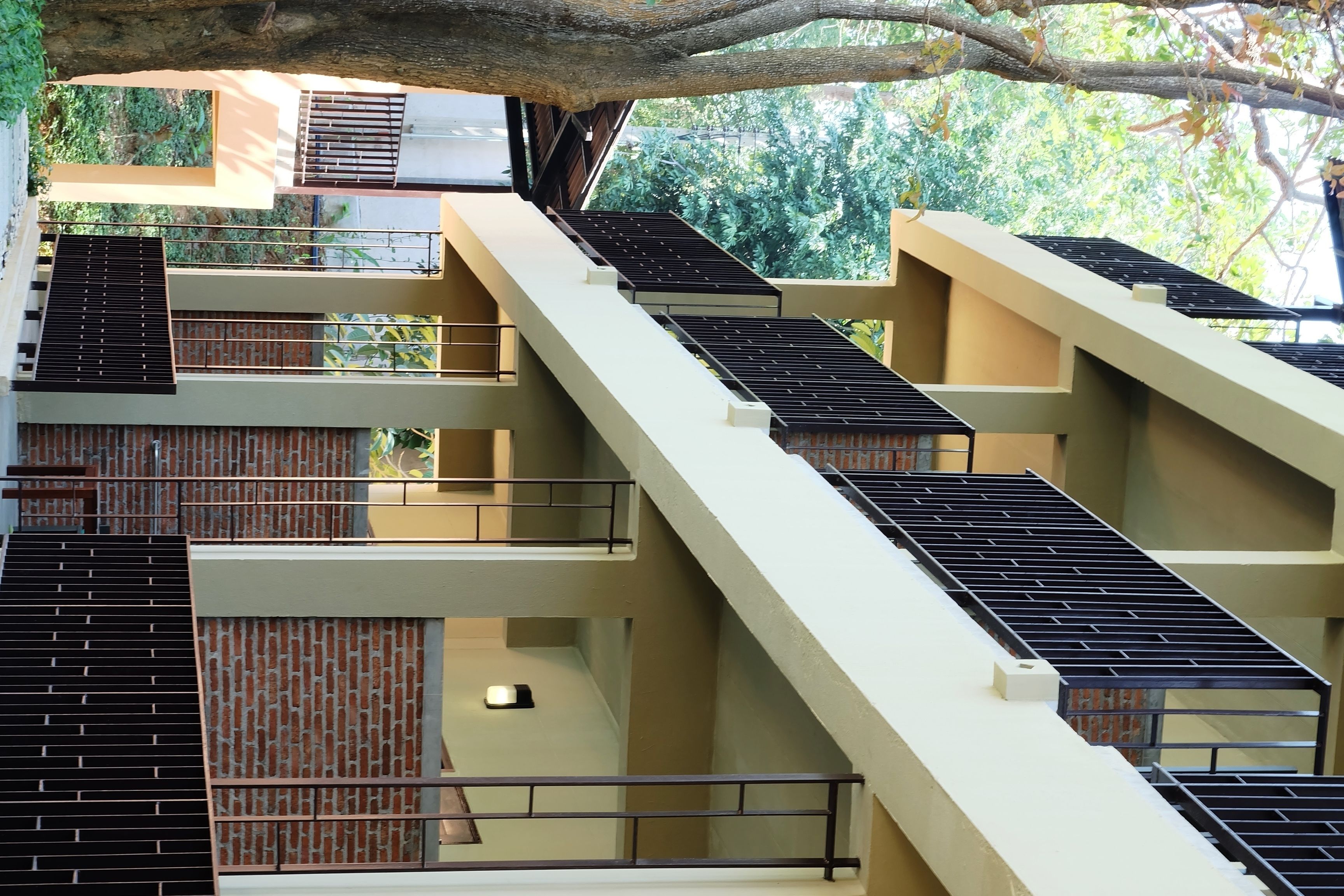 A multi-level building with balconies and staircases.