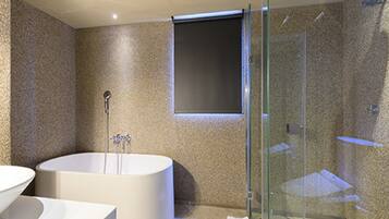 A modern bathroom with a freestanding bathtub, a glass-enclosed shower, and a large mirror.