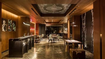 Welcome to our reception area, featuring a long reception desk, framed botanical prints, and a cozy lounge space.