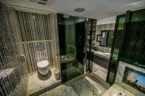 A modern bathroom with a glass-enclosed shower, a marble sink, and a toilet. - Region Motel (Lukang)