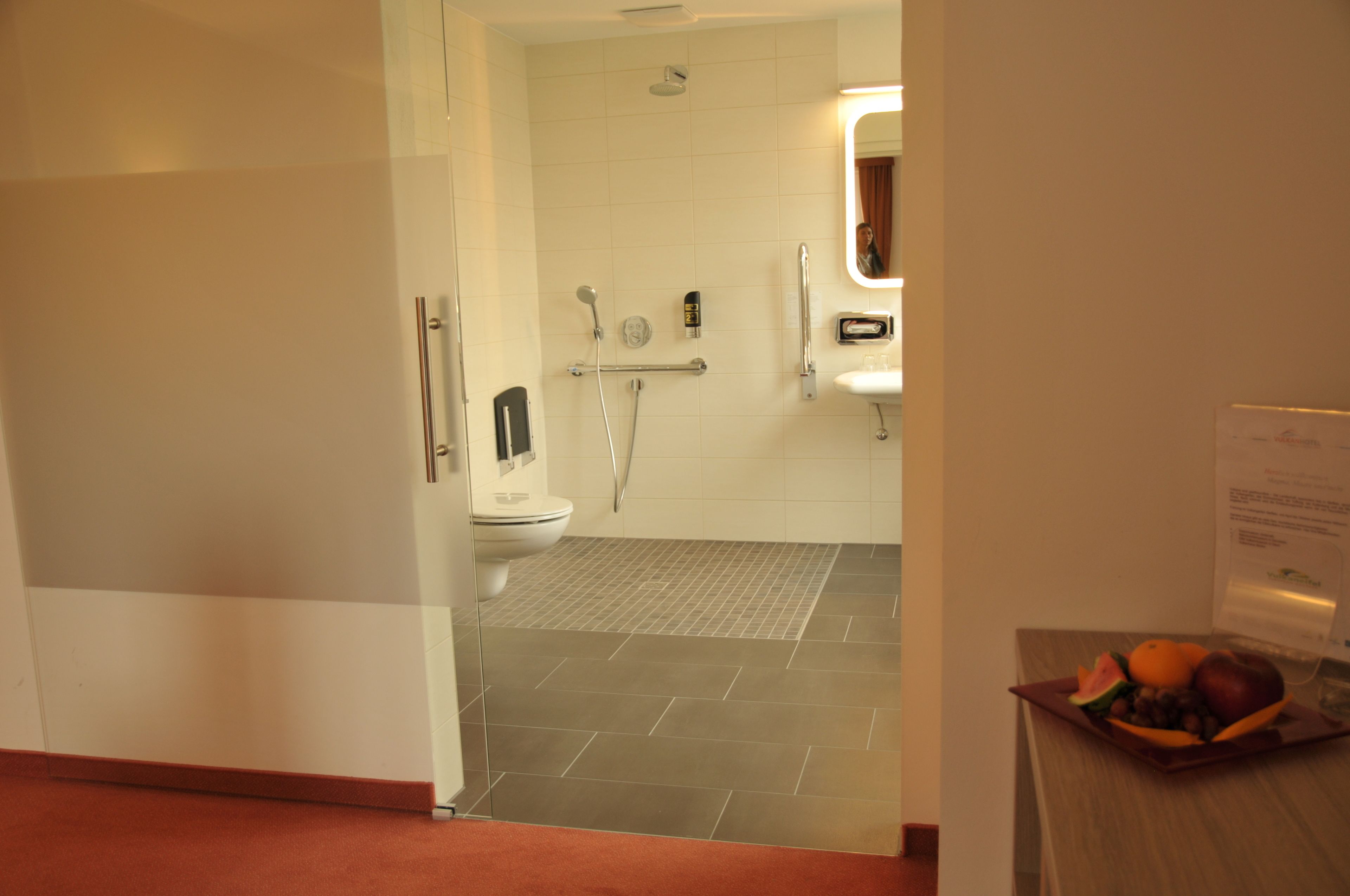A modern bathroom with a toilet, bidet, and shower.