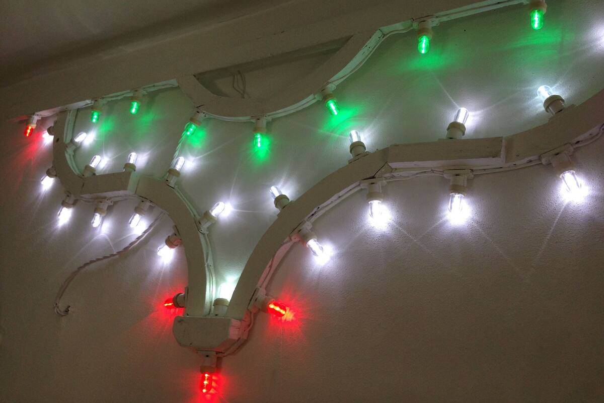 A ceiling with a row of lights, some of which are turned on.