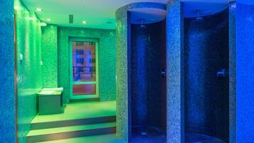 Bathroom features a large mirror with an outside view, a sink, and a shower area with a glass enclosure.
