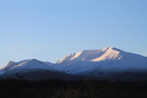 A snow-covered mountain range with clear skies.