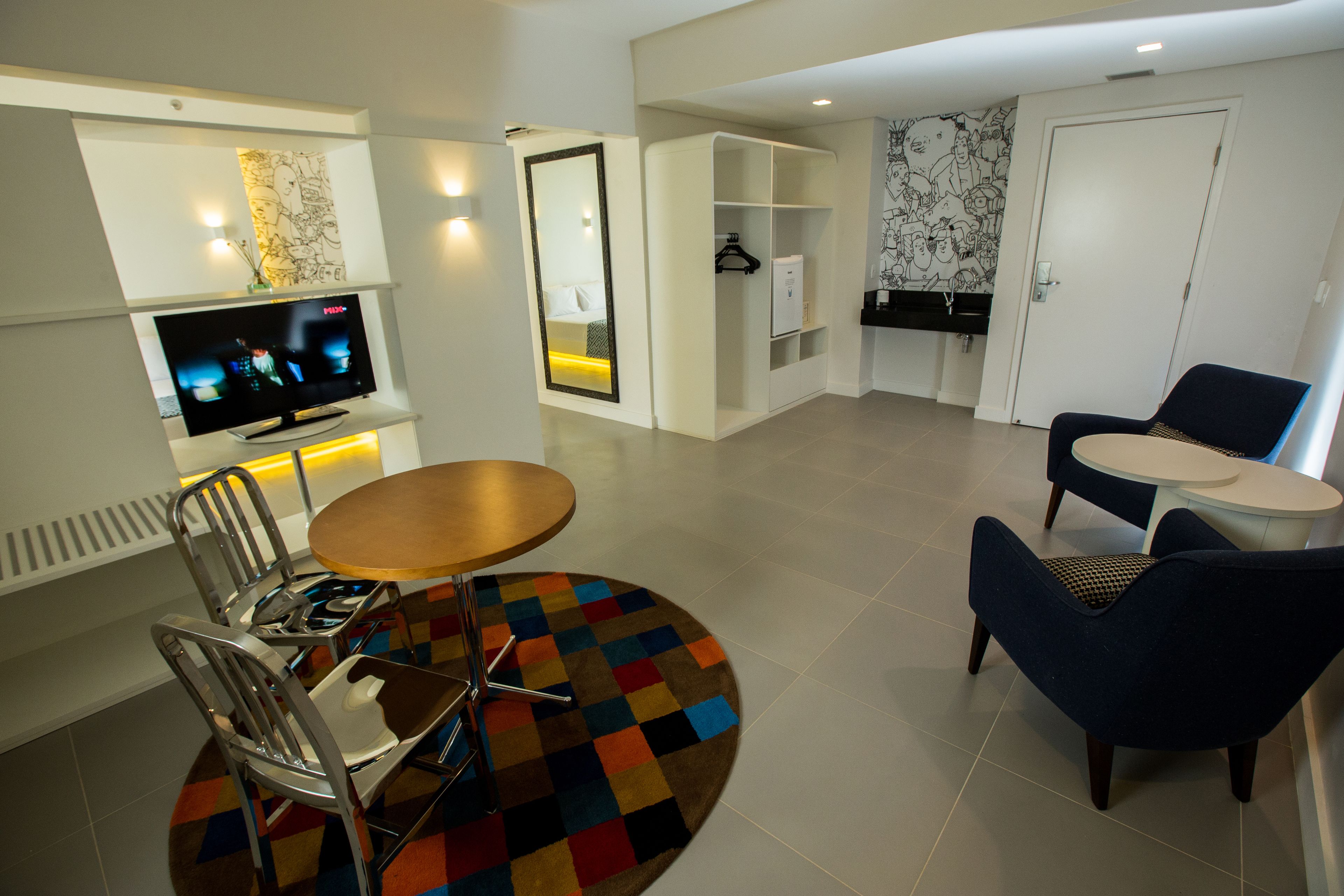 standard room, multiple beds | living area | 40-inch led tv with cable channels, tv, ipod dock