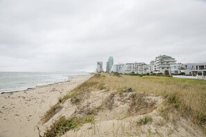 On the beach, white sand, beach towels, windsurfing