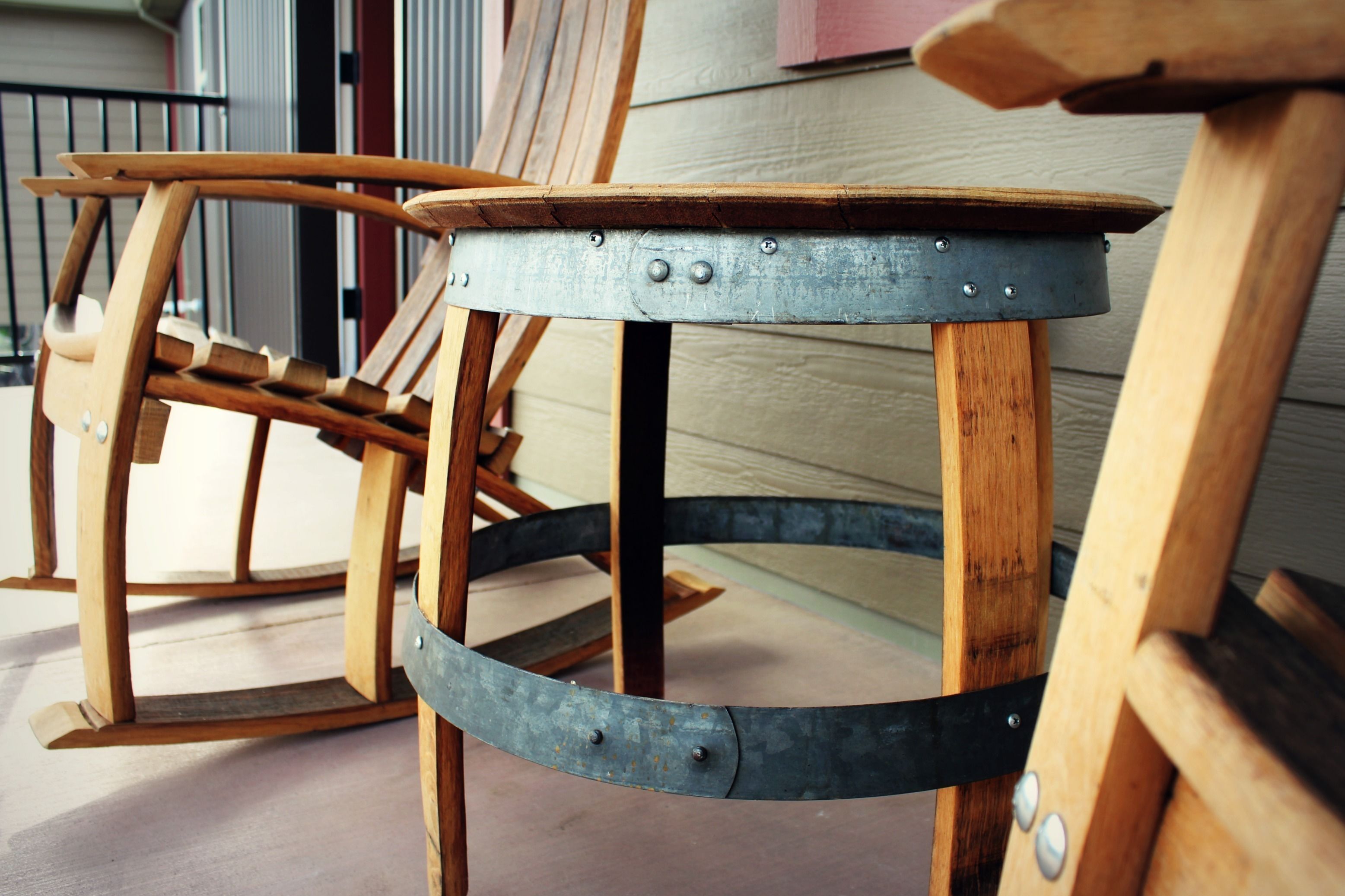 A rustic wooden chair with metal accents and a round table with a metal base.