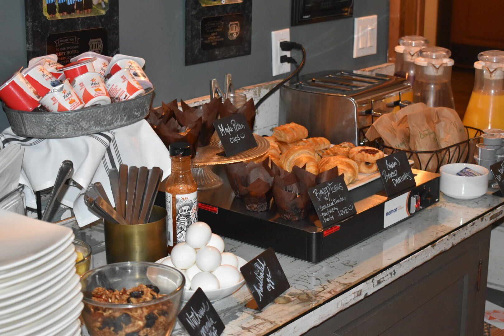 A breakfast buffet with various food items and condiments.